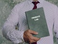 Jurist holds PROBATE LAW book. Probate lawÃÂ refers to the process that manages any assets and debts left behind by a deceased